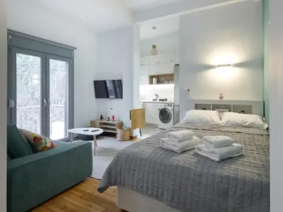 a bedroom with a bed with towels on it at Modern & Cozy Studio in Kypseli in Athens