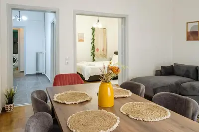 a living room with a table and a couch at Athenian sunlit central flat! in Athens