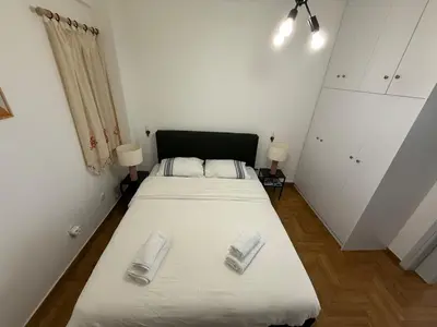 a bedroom with a bed with two towels on it at Athenian sunlit central flat! in Athens