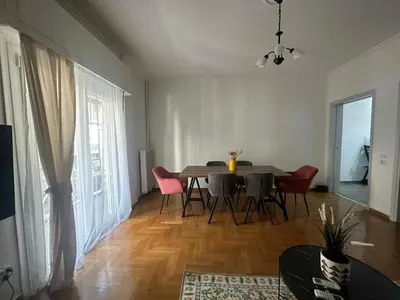 a living room with a dining room table and chairs at Athenian sunlit central flat! in Athens