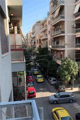 a view of a city street with cars parked at Athenian sunlit central flat! in Athens