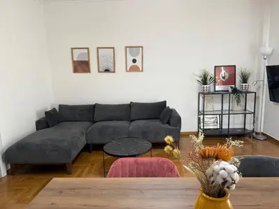 a living room with a couch and a table at Athenian sunlit central flat! in Athens