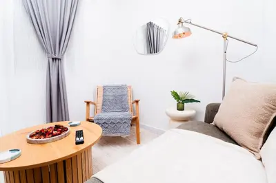 a living room with a couch and a table at Romantic Garden Central Rooftop Gym Fast Wifi in Athens