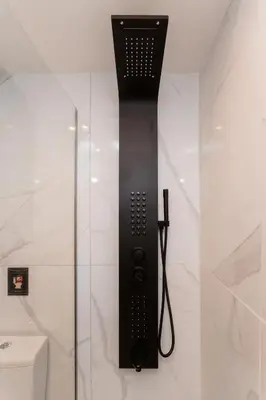 a shower with a black hair dryer in a bathroom at Romantic Garden Central Rooftop Gym Fast Wifi in Athens