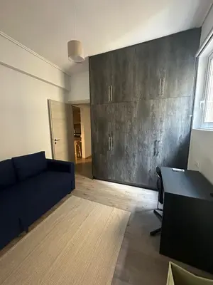 a living room with a couch and a table at Spacious sunlit 3bd flat,2 bathroom best location! in Athens