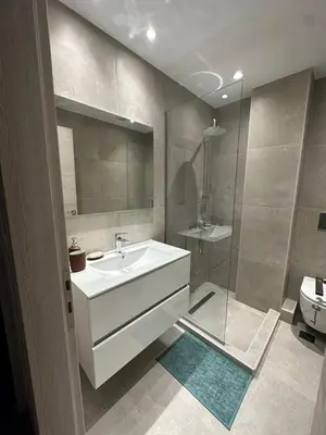 a bathroom with a white sink and a shower at Spacious sunlit 3bd flat,2 bathroom best location! in Athens
