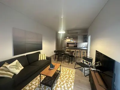 a living room with a couch and a table at Spacious sunlit 3bd flat,2 bathroom best location! in Athens