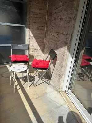 two chairs with red cushions sitting on a porch at Spacious sunlit 3bd flat,2 bathroom best location! in Athens