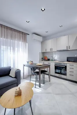 a living room with a couch and a table at Suncity apartments with garden in Athens
