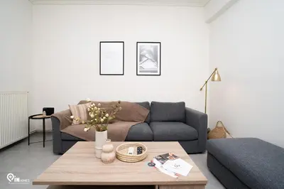 a living room with a couch and a coffee table at Irene's Home - Serene City Sanctuary in Athens in Athens