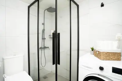 a glass shower in a bathroom with a toilet at Irene's Home - Serene City Sanctuary in Athens in Athens