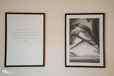 two framed pictures of a palm tree on a wall at Irene's Home - Serene City Sanctuary in Athens in Athens