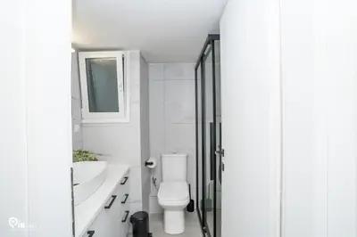 a bathroom with a toilet and a sink and a shower at Irene's Home - Serene City Sanctuary in Athens in Athens