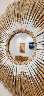 a circular mirror in a room with a table at Best Stay Athens Metro in Athens