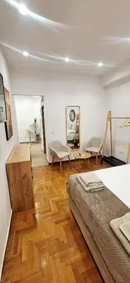 a bedroom with a bed and a wooden floor at Best Stay Athens Metro in Athens