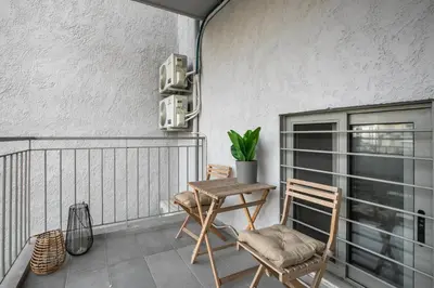 a balcony with two chairs and a wooden table at Cassiopeia - Charming Studio & Balcony in Athens in Athens