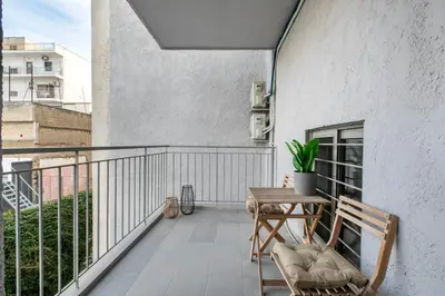a balcony with a table and chairs on a building at Cassiopeia - Charming Studio & Balcony in Athens in Athens