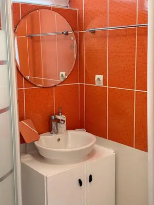 a bathroom with a sink and a mirror at Cozy studio 10minutes from airport in Markopoulo