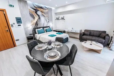 a living room with a bed and a table and chairs at Sapfo in Athens