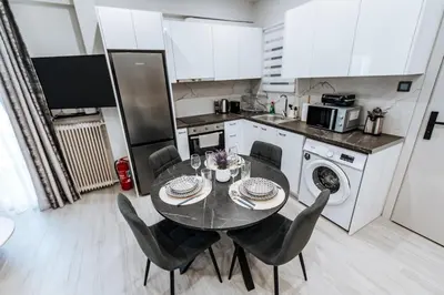 a kitchen with a table and chairs in a kitchen at Sapfo in Athens