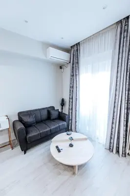 a living room with a couch and a coffee table at Sapfo in Athens