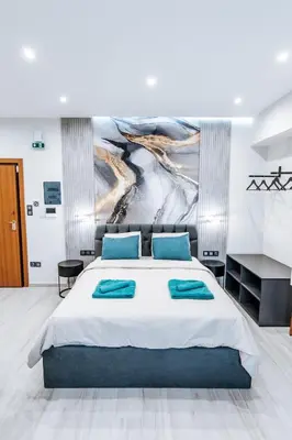 a bedroom with a bed and a painting on the wall at Sapfo in Athens