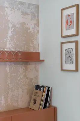 a shelf with books and pictures on a wall at Stylish 4BR Top Floor w Private Rooftop Lounge in Athens