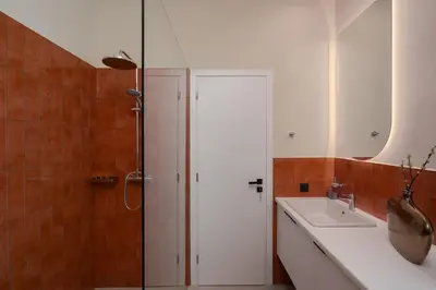 a bathroom with a shower and a white sink at Stylish 4BR Top Floor w Private Rooftop Lounge in Athens