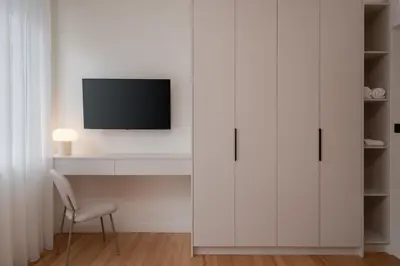 a white living room with a tv and a chair at Stylish 4BR Top Floor w Private Rooftop Lounge in Athens