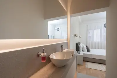 a bathroom with a bowl sink and a bed at Stylish 4BR Top Floor w Private Rooftop Lounge in Athens