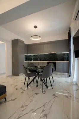 a dining room with a table and chairs in a kitchen at Athenian Hospitality in Athens