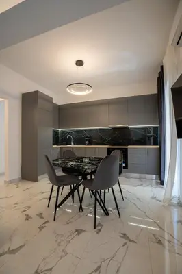 a dining room with a table and chairs in a kitchen at Athenian Hospitality in Athens