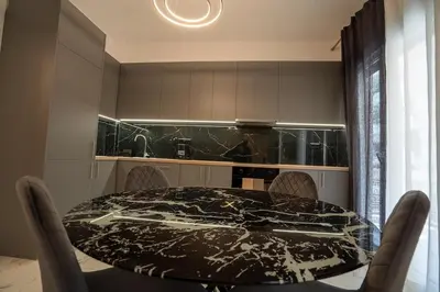 a kitchen with a table with chairs and a counter at Athenian Hospitality in Athens