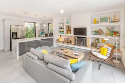 a living room with a couch and a table at Private Garden Duplex in Voula by GHH in Athens