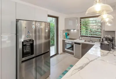 a kitchen with a stainless steel refrigerator and a sink at Private Garden Duplex in Voula by GHH in Athens