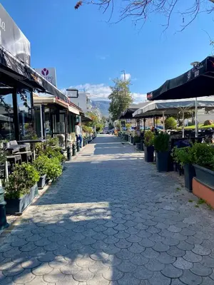 a cobblestone street with a group of shops at Athens Victoria's Family Apartment in Athens