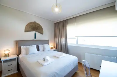 a bedroom with a bed with two towels on it at Luxury Apartment in Glyfada with Sea View in Athens