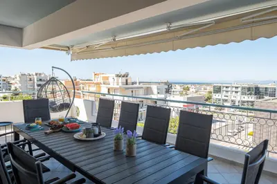 a table and chairs on a balcony with a view at Luxury Apartment in Glyfada with Sea View in Athens