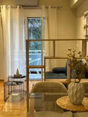 a living room with a glass table and a couch at Voulis Apartment 1 in Athens