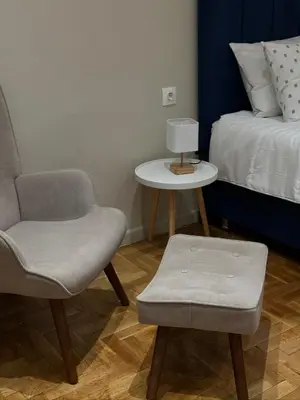 a bedroom with a bed and a chair and a table at Voulis Apartment 1 in Athens