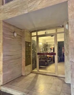 an entrance to a building with glass doors at Voulis Apartment 1 in Athens