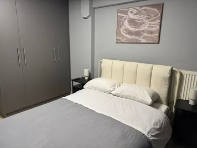 a bedroom with a large bed with white sheets at Elegant Escapes 8 in Athens