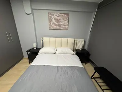 a bedroom with a large bed with two night stands at Elegant Escapes 8 in Athens
