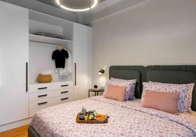 a bedroom with a bed with a tray of fruit on it at Urban Blush Pangrati by Premium Key in Athens