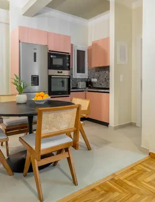 a kitchen and dining room with a table and chairs at Urban Blush Pangrati by Premium Key in Athens