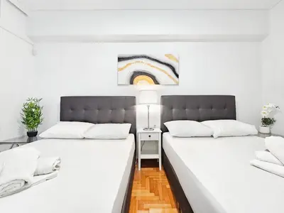 two beds sitting next to each other in a room at Casa Divas Galaxy Suite in Athens
