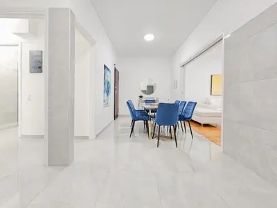 a dining room with blue chairs and a table at Casa Divas Galaxy Suite in Athens