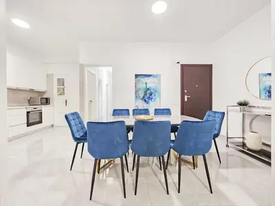 a dining room with a table and blue chairs at Casa Divas Galaxy Suite in Athens