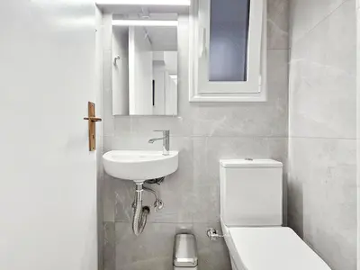 a bathroom with a white toilet and a sink at Casa Divas Galaxy Suite in Athens