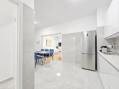 a kitchen with a refrigerator and a table with chairs at Casa Divas Galaxy Suite in Athens